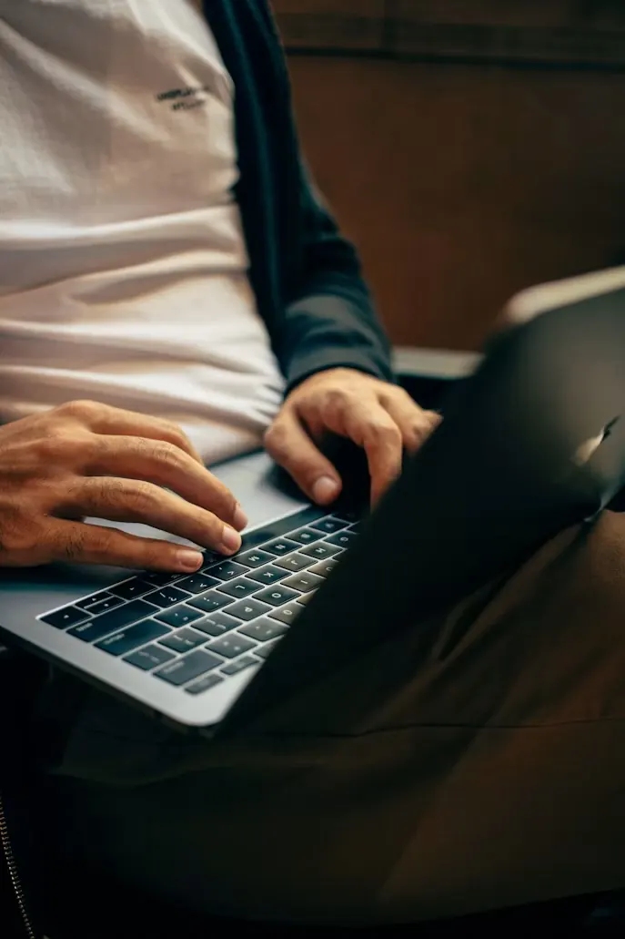 A person typing on a laptop
